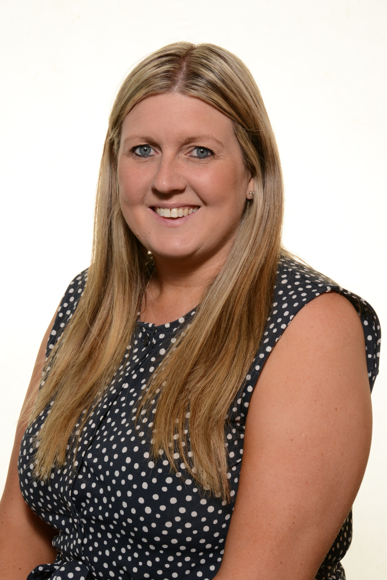 Mrs A Griffiths, Office Manager at Penkridge Middle School, wearing a sleeveless patterned dress  
