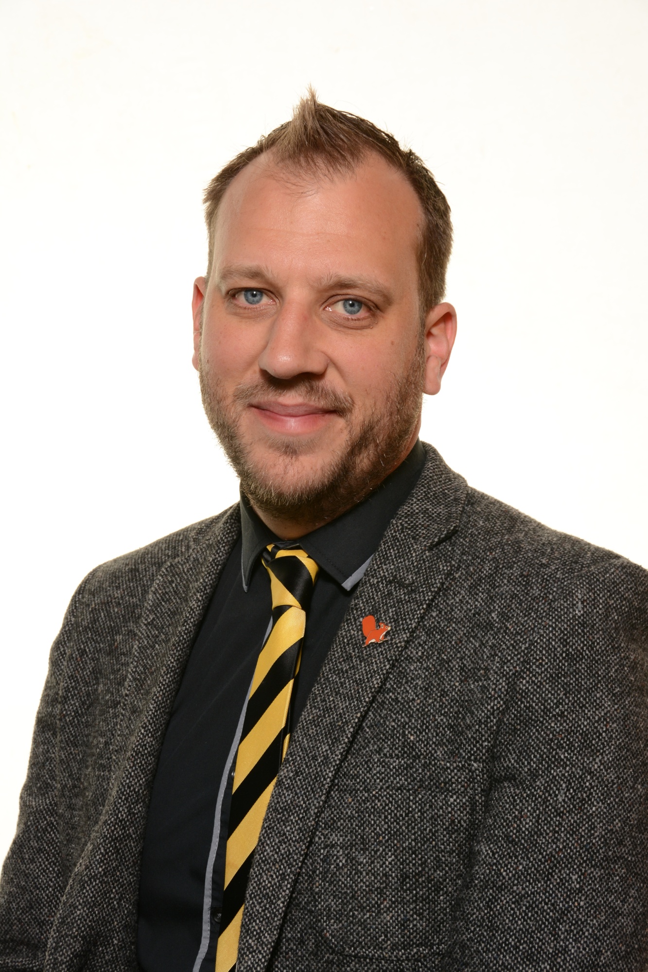 Mr L Meredith, Assistant Headteacher at Penkridge Middle School, wearing a grey suit and striped tie